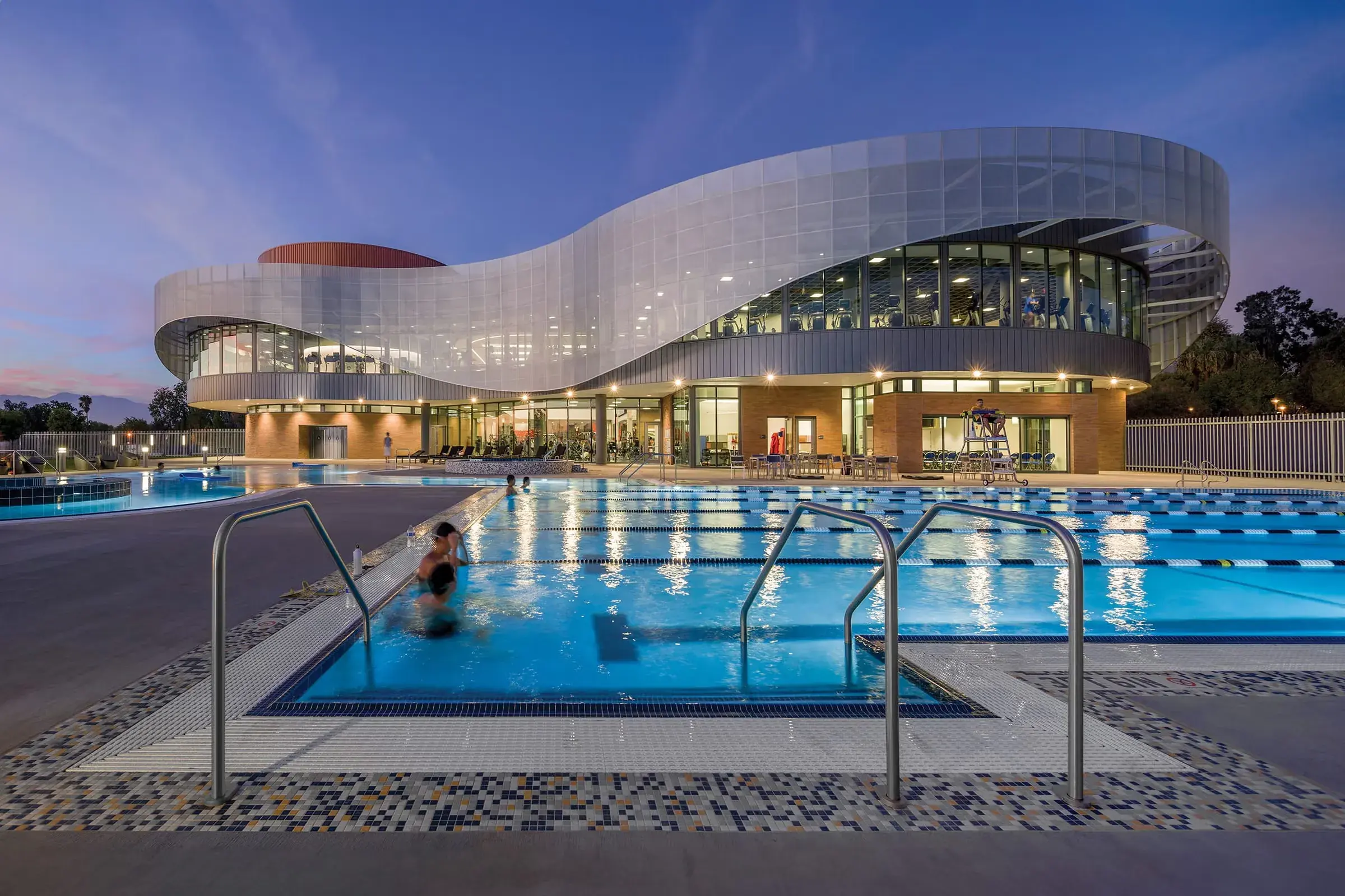 The Student Recreation Center and its outdoor pool at dusk